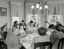 May 1942. "Southington, Connecticut. The family of Ralph Hurlbut. A Sunday dinner honoring Corporal Robert Hurlbut, twenty-one, home on his first furlough from the Army. All of the Hurlbuts are on hand for the occasion, including the married and grandchildren. Corporal Robert is not the only Hurlbut serving his country. The elder Hurlbut (far left) works in a defense plant and Mrs. Hurlbut and all of the children old enough are enrolled in various American voluntary services." Photo by Fenno Jacobs, Office of War Information. View full size.