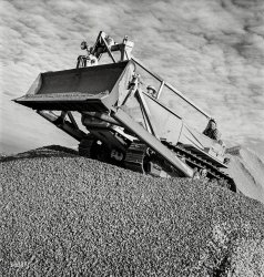 November 1942. "Columbia Steel Company at Geneva, Utah. Bulldozer handling gravel for concrete during the construction of a new steel mill which will make important additions to the vast amount of steel needed for the war effort." Photo by Andreas Feininger for the Office of War Information. View full size.