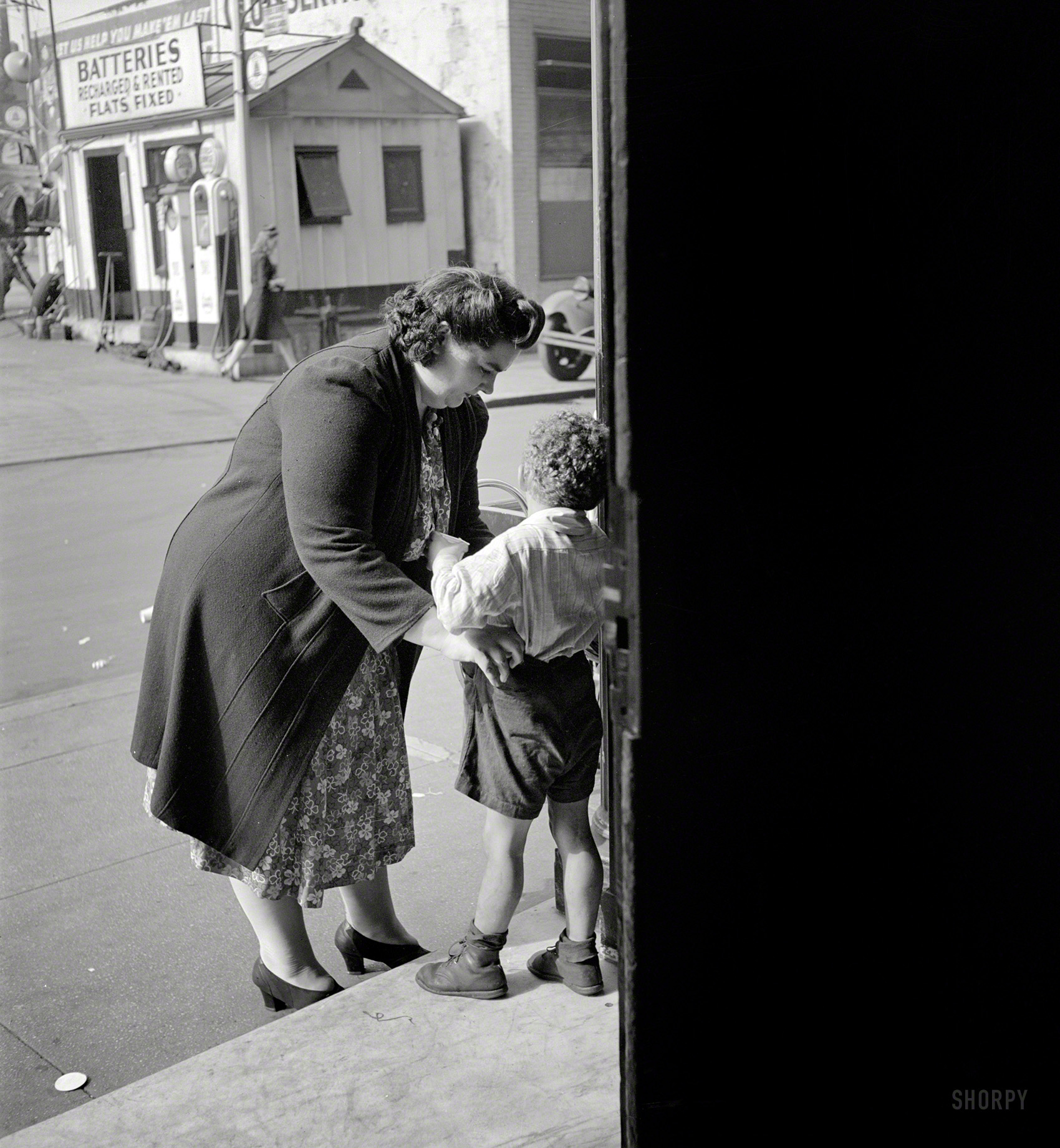 May 1944. "New York. A small boy who receives day care at Greenwich House while his mother works." And more of that service station across the street. Photo by Risdon Tillery for the Office of War Information. View full size.