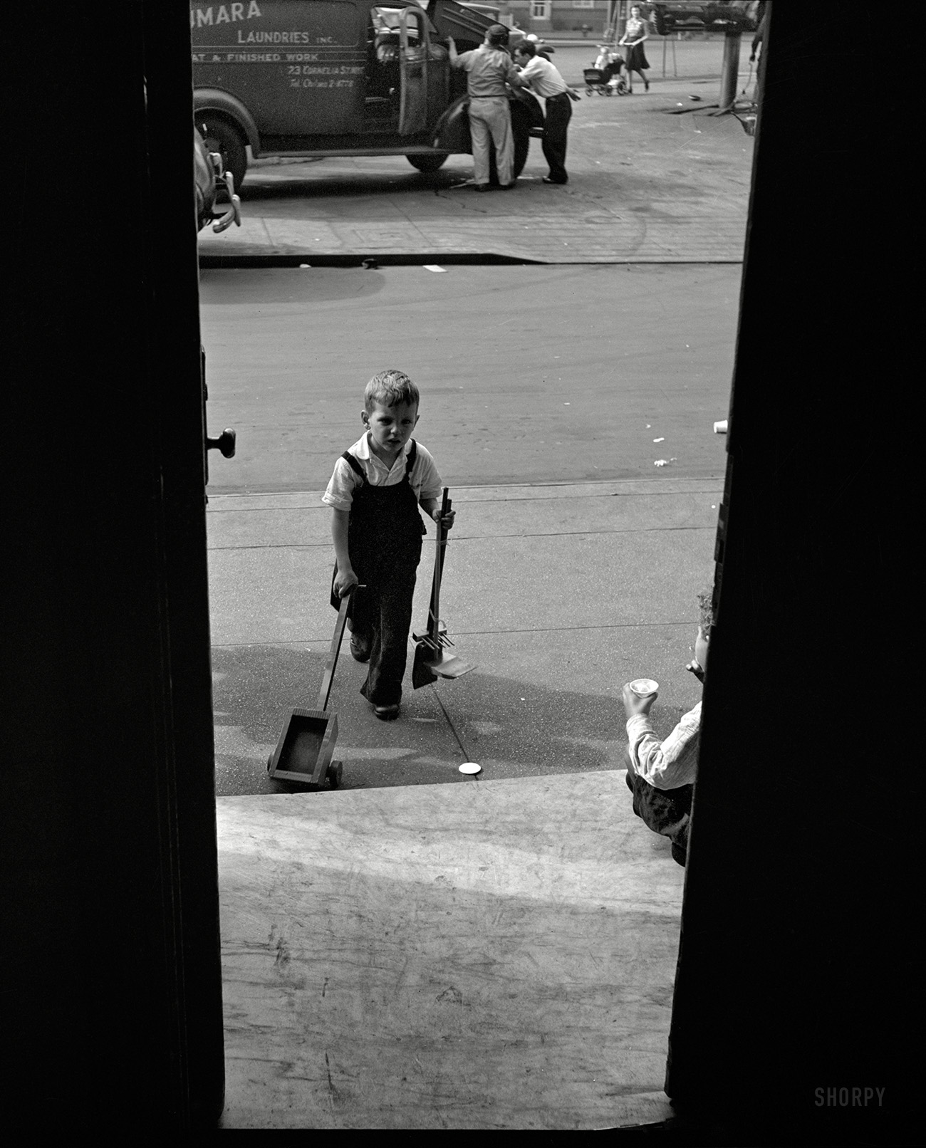 May 1944. "New York. A small boy arriving at Greenwich House, where he is enrolled in a nursery school program, receives day care while his mother works." Another perspective on the door glimpsed earlier here. Photo by the wonderfully named Risdon Tillery for the Office of War Information. View full size.