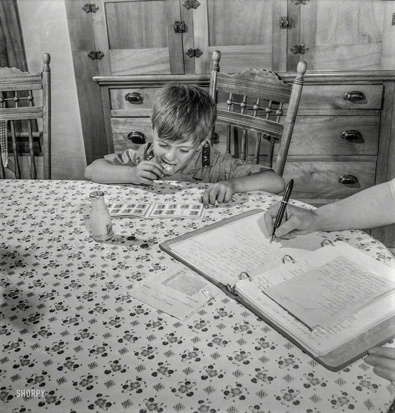 July 1942. East Montpelier, Vermont. "Richard, age 5, son of the farmer Charles Ormsbee, has his own war project -- he has agreed to lick all the savings stamps for the family." Photo by Fritz Henle, Office of War Information. View full size.
