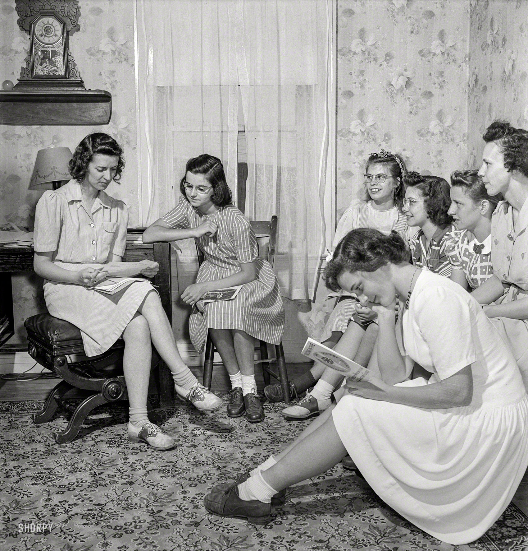 July 1942. "East Montpelier, Vermont. Marilyn Ormsbee, in striped dress (last seen here), is president of her 4-H Club, the Montpelier Center Girls, where she learns how to sew and cook economically and well." Medium format negative by Fritz Henle for the Office of War Information. View full size.