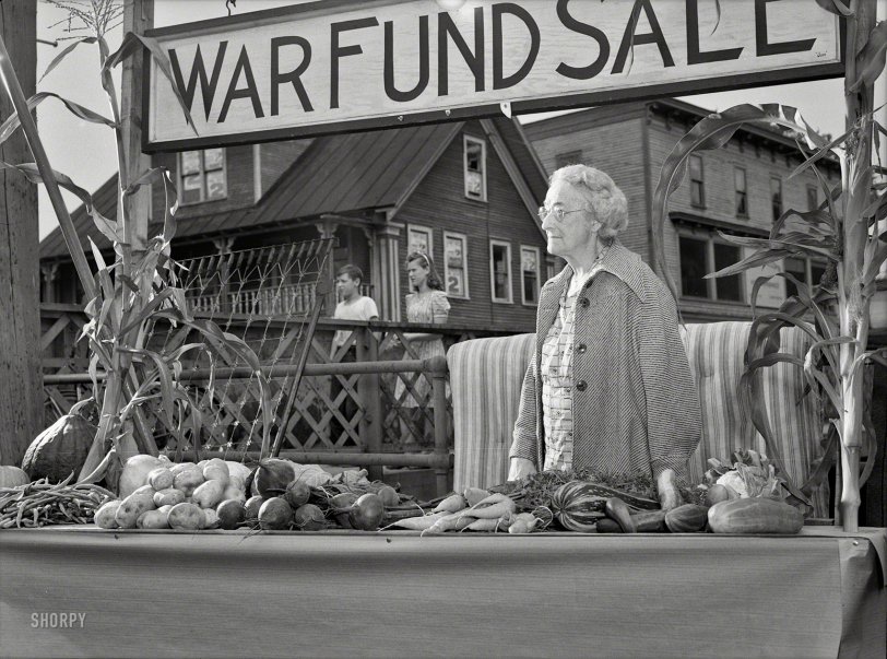 October 1942. Hardwick, Vermont. "Mrs. Alice White at the Victory Store vegetable counter selling donated farm produce, money from which will go to the War Fund." Photo by Albert Freeman, Office of War Information. View full size.
