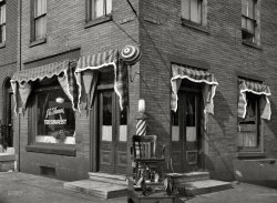 Spring 1937. "Barber shop at 19th and Bainbridge Streets, Philadelphia." If the twirling candystripes don't pull you in, there's always the psychedelic eyeball. Photo by Paul Vanderbilt for the Resettlement Administration. View full size.