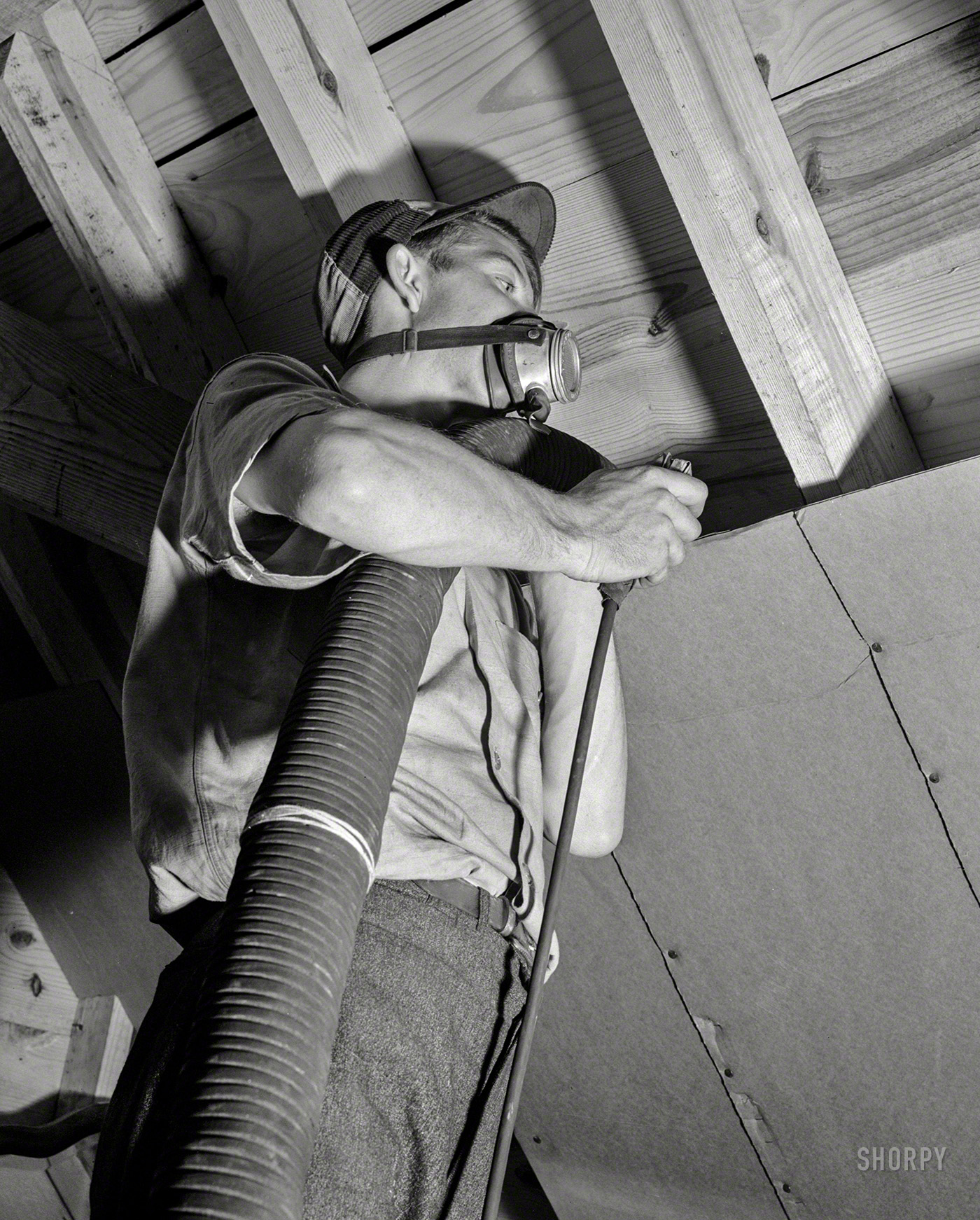 Washington, D.C., circa 1942. "Conservation of fuel oil -- rock-wool attic insulation." Office of War Information photo. View full size.