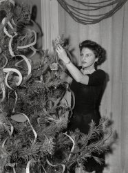 December 1943. Washington, D.C. "Decorating the tree at a Christmas Eve party given by Local 203 of the United Federal Workers of America, Congress of Industrial Organizations (CIO)." Photo by Joseph A. Horne. View full size.