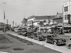 April 1942. "Portuguese-American communities in California. Main street (East 14th at Callan) in San Leandro." Our title is in honor of that low-slung, supercharged  Graham Hollywood -- one of the decade's quirkier cars -- parked at the curb. Acetate negative by Russell Lee for the Foreign Information Service of the U.S. Office of Coordinator of Information. View full size.