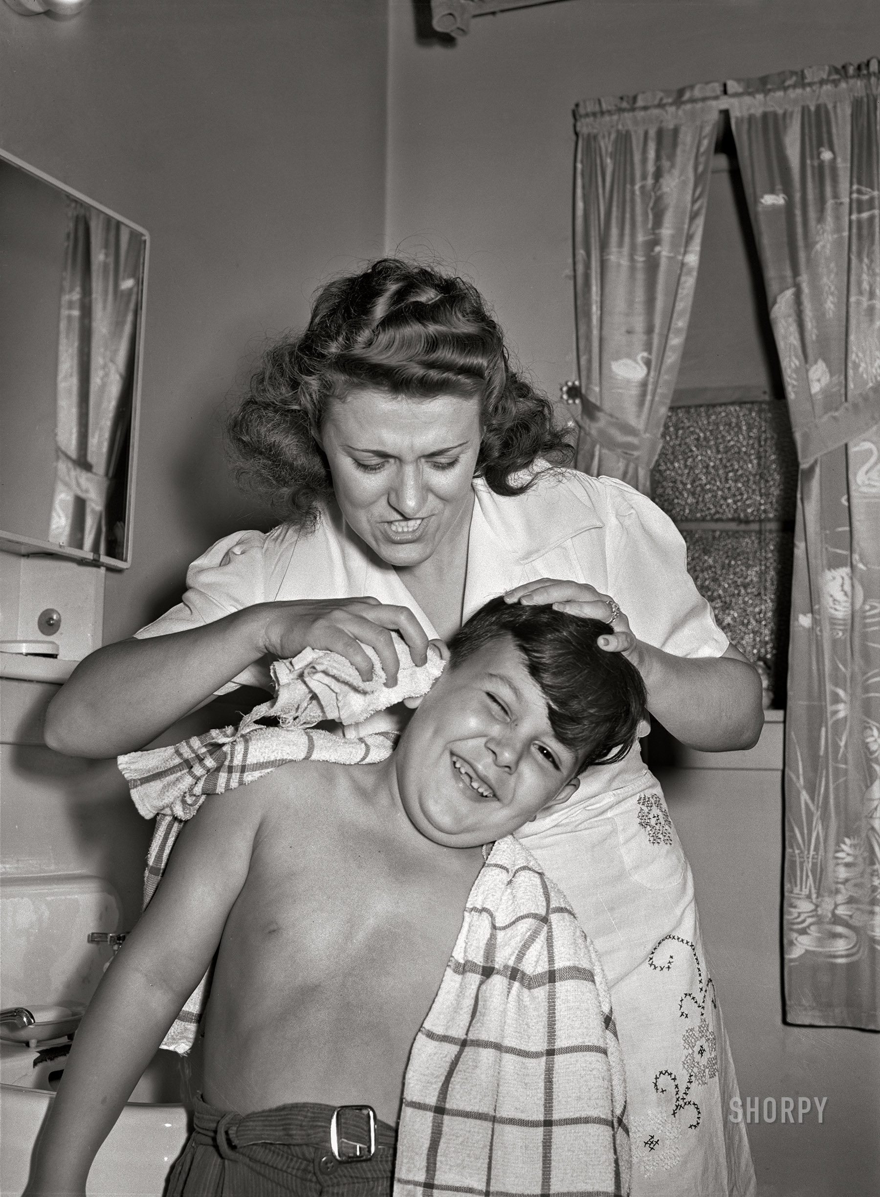June 1942. "Brooklyn, New York. Red Hook housing project. Mrs. Caputo washes son Jimmy's ears. He is recovering from infantile paralysis." Photo by Arthur Rothstein. View full size.