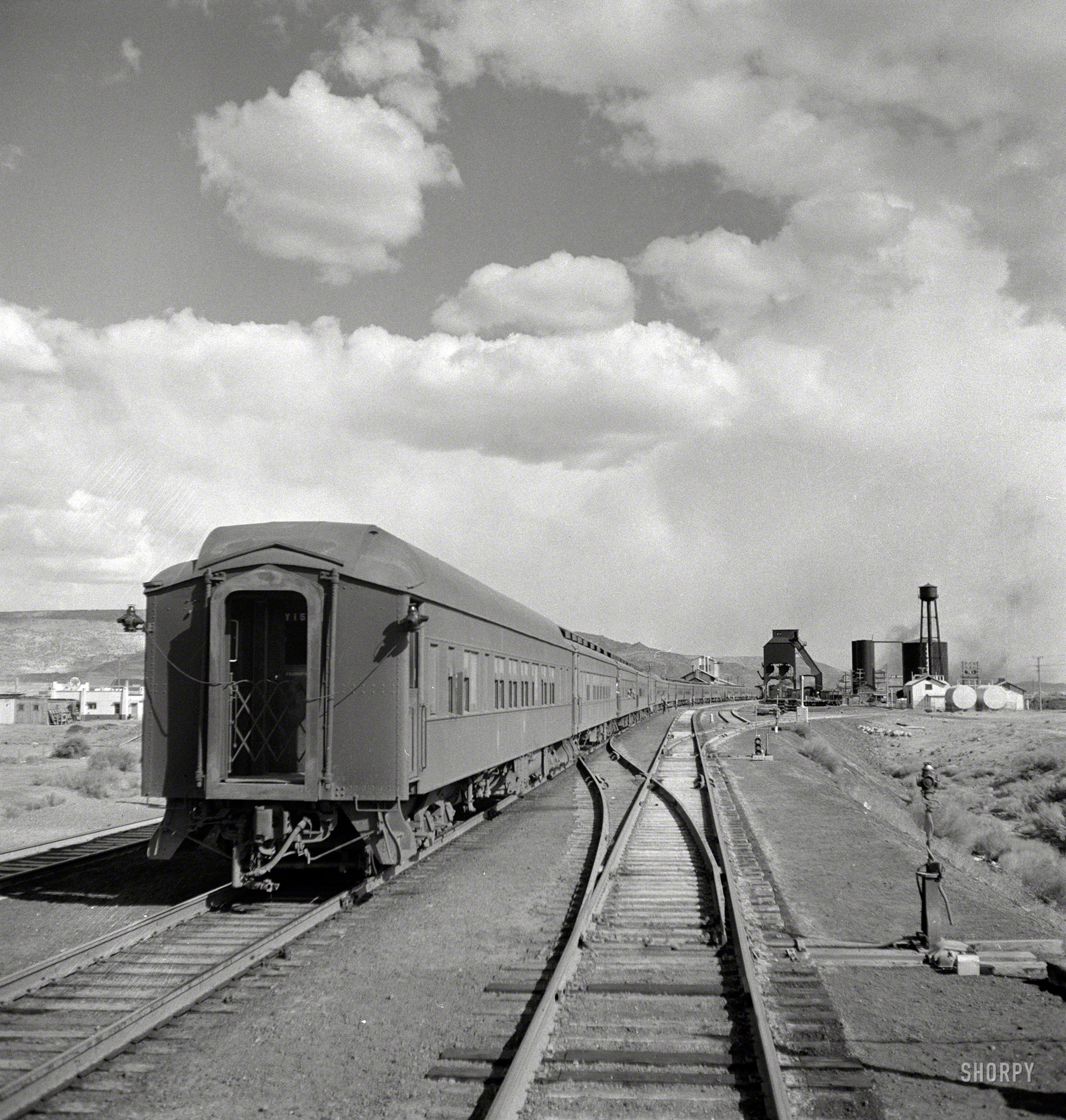 March 1943. "Grants, New Mexico. Passing a troop train stopping for coal and water on the Atchison, Topeka & Santa Fe between Belen and Gallup." Photo by Jack Delano for the Office of War Information. View full size.