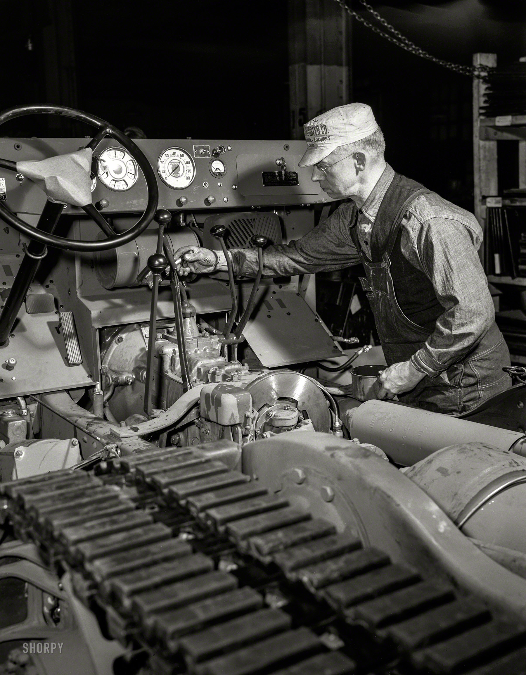December 1941. "White Motor Company, Cleveland. A halftrack scout car gets a touch-up job on the chassis assembly line. A durable finish protects the metal -- and helps to bring the vehicle up to Army standards of smartness." 4x5 negative by Alfred Palmer for the Office for Emergency Management. View full size.