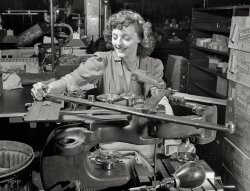 &nbsp; &nbsp; &nbsp; &nbsp; UPDATE: This is, as far as the Shorpy Research Department can tell, from a series of photos taken by Andreas Feininger in June 1942 at the East Hartford, Conn., engine manufacturing plant of Pratt & Whitney Aircraft.
Circa 1942. We've lost the caption for this photo of a lady operating yet another War-Winning Widget in Factorytown, USA. What is she making? View full size.