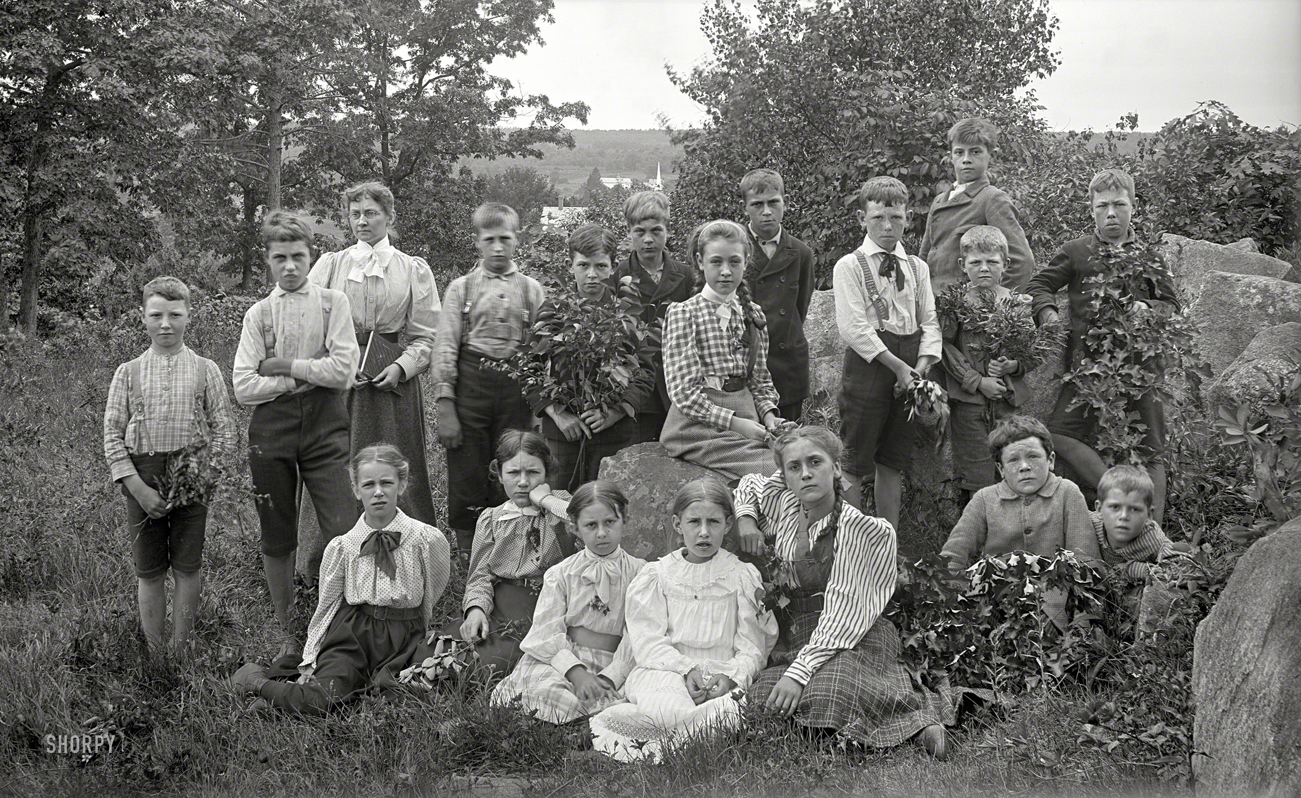From somewhere in New England circa 1900 comes the final plate from our recent batch of serious-looking class photos, this group being particularly well camouflaged with greenery. 5x8 inch glass negative. View full size.