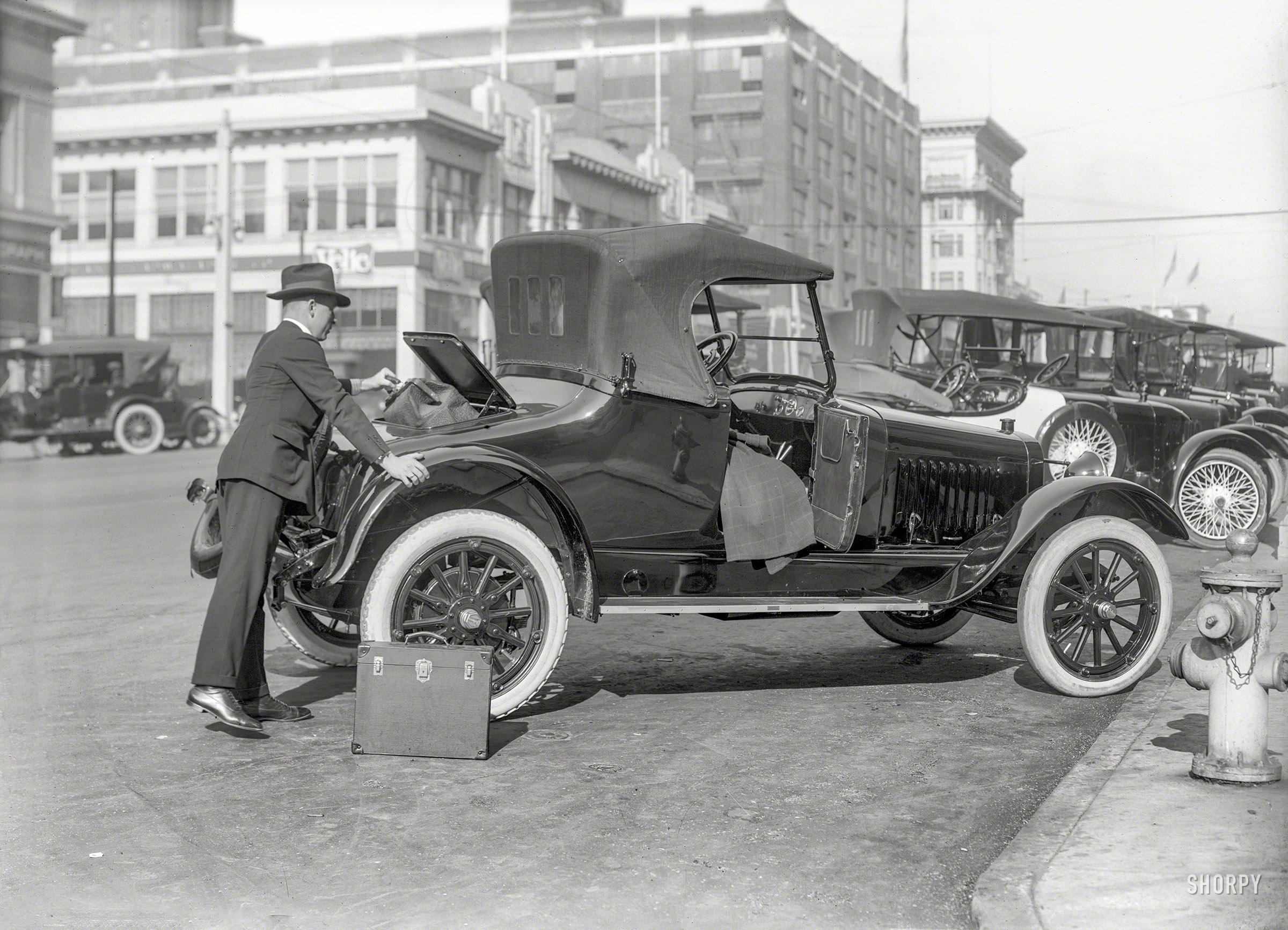 San Francisco circa 1918. "Chalmers Model 6-30 roadster facing N.W. corner Van Ness Avenue and Sutter Street." Note the Velie showroom at the intersection. 5x7 inch glass negative by Christopher Helin. View full size.