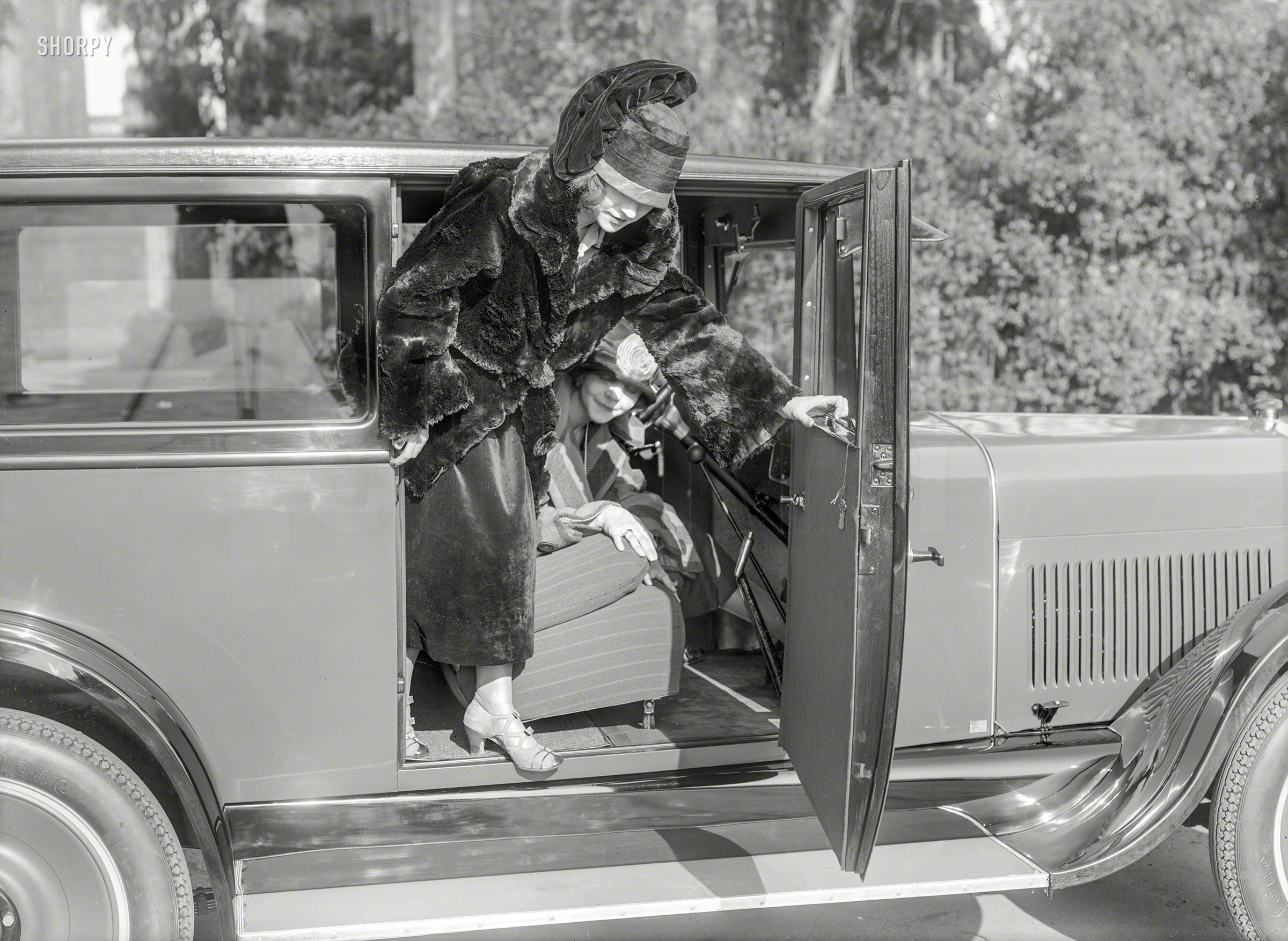 From circa 1924 San Francisco comes this modishly draped miss descending from her sedan. 5x7 glass negative by Christopher Helin. View full size.