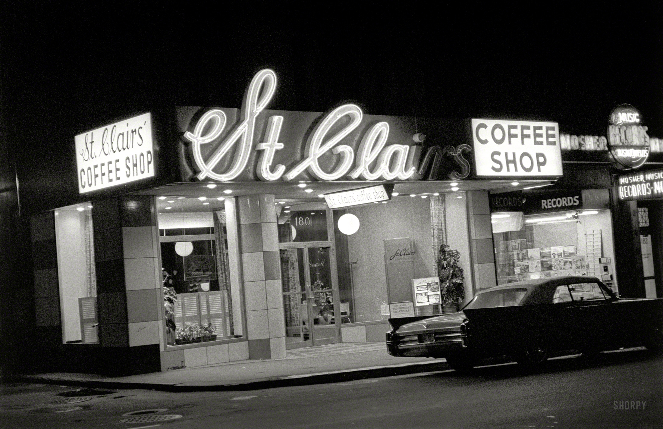 "St. Clairs Coffee Shop and Mosher Record Store, Boston, night." Neon with a side of tailfin. 35mm negative, photographer unknown. View full size.