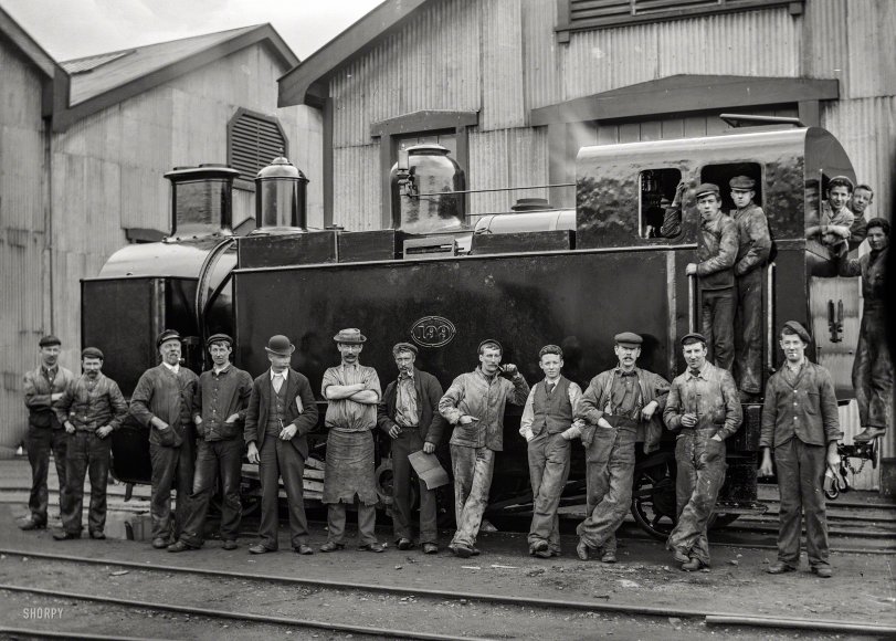 &nbsp; &nbsp; &nbsp; &nbsp; Petone Railway Workshops circa 1905. H class steam locomotive, 0-4-2T type, for use on the Fell system on the Rimutaka Incline. NZR 199 built at Avonside Railway Workshops in 1875, went into service on the Rimutaka Incline in January 1877, written off and preserved in March 1956.
One of more than 2,000 train-related glass negatives, now in the collections of the Alexander Turnbull Library, taken by New Zealand Railways employee and amateur photographer Albert Percy Godber (1875-1949). View full size.
