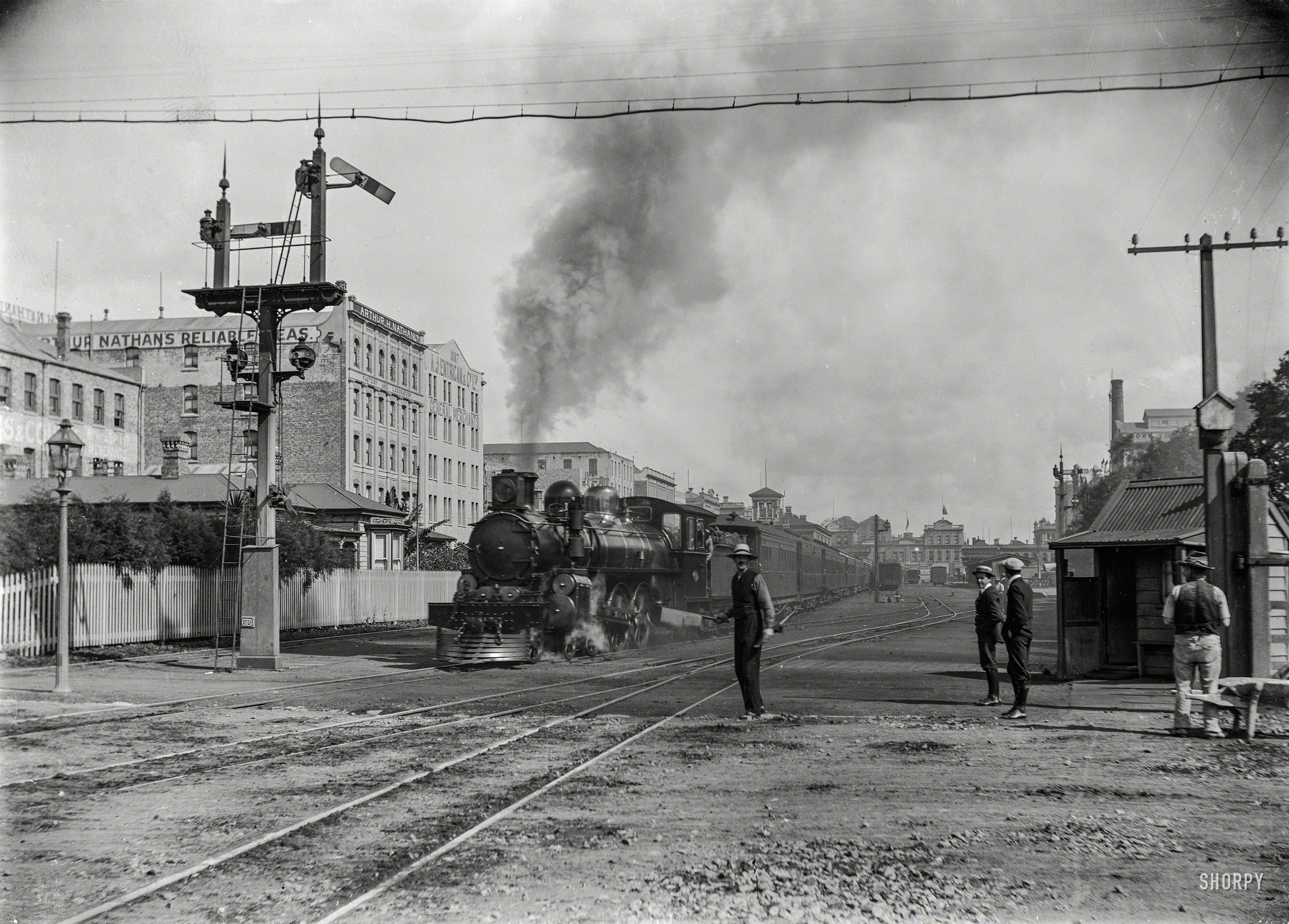 New Zealand in 1909. "The Rotorua Express leaving Auckland, alongside Customs Street East." Glass negative by A.P. Godber. View full size.