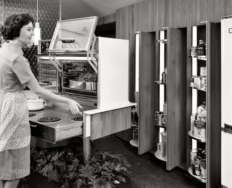 November 1960. New York. "General Motors Motorama '61 at the Waldorf-Astoria. 'Ideas for Living' exhibit features model kitchen with two-oven Frigidaire Flair range with pull-out burners, mounted on a slim pedestal rising from a bed of growing plants. 'About-Face' pantry has hidden shelves that pivot out from storage wall at the touch of a button." View full size.
