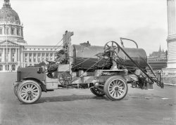 San Francisco City Hall circa 1919. "Peerless truck." Three young ladies aboard what seems to be some sort of street-cleaning, finger-ripping machine. Hide your children and stand clear! 5x7 glass negative by Christopher Helin. View full size.
FrighteningThe single most dangerous street machine I have ever seen.
Before Rosie the RiveterI love showing people these sorts of images, in light of the fact that most of our images of American Women in Action come from the WWII era, where they were pressed into service because men had gone to war. These ladies, in 1919, look like they just ... have jobs. I love the proto-Rosie coveralls and headscarves, the likes which show up again a scant fifteen years later as something unusual in "The Saturday Evening Post" and LIFE magazines.
Crazy Contraptions I think if Rube Goldberg had ever designed a truck, it would look just like that.
Finger ripping is putting it mildy.That truck looks as if it was designed to inflict injury. I hope those women got hazardous duty pay.
AwesomeI just stumbled upon this site.   I love vintage photos, and this one is terrific -- who knew that there were women filling roles like this in the early 20th Century?
Safety guards ! Safety guards!We don't need no steenking safety guards!
GoldbergianIn 1904, freshly minted from the UC-Berkeley Engineering School, Rube Goldberg took a job with the San Francisco Department of Water and Sewers.  Although he left in a few months to be a cartoonist for the SF Chronicle, it appears he kept his hand in by designing machines for the Department.
More Danger LurkingAnd if you do get passed the hair pulling - finger ripping apparatus, there's always that two foot section of lead pipe on the floor to worry about.
Tot-TwirlerWhen I see gear like this, I'm just going to start labeling it "babyshredder."
The third operator was necessary for when the first two inevitably got caught in the machinery.
Count your fingersI trust those open belt and chain drives are OSHA approved.  But I bet it was more interesting when you could see the parts of machinery doing their thing. 
Pilot for short subject seriesI believe this is a still from "The Three Stoogettes", an unsold movie short series which was way ahead of its time --  "We'll clean your sheets, we'll clean your streets, in half the time, no more grime ... zots!"
PeerlessI infer that to mean returning from the job with fewer of one's peers in the passenger seat than one left with that morning.
Hey HoneyThis truck looks a heck of a lot like a "honey dipper" to me. Other than the 1919 running gear and mechanism, they still look like that today.
[Like our previous street flusher, this rig was one of many deployed as a public-health measure during the flu epidemic of 1918-1920 to control dust. - Dave]
WowserDefinitely high tech for its day. The belt drives appear to be increasing the speed to a (pump?) under the end of the tank. I can't see any spray nozzles so I would assume it's used to refill the tank?
Street Cleaner??It looks more like the kind of equipment that would be used to spread liquid asphalt (aka tar) on a roadway before spreading a layer of stone on it. Admittedly, it's very clean, so this might have been a publicity shot for the manunfacturers. "So simple the ladies can operate it!"
You can&#039;t make this upThanks to Jim Page for informing us "Here we see a 1918 Peerless Isadora-model Pinchmaster 3000 truck". "Pinchmaster", could there be a more appropriate name of it than that?
[Jim did make that up. The reference to Isadora Duncan was especially sly. - Dave]
Original power washerBelt driven PTO runs the rear mounted pump. Two control levers by the closest operator regulate how much flow is produced to swish the road apples to the gutter.
Vehicle IDI usually allow others to handle the vehicle ID chores here at Shorpy, but since no one has stepped up: Here we see a 1918 Peerless Isadora-model Pinchmaster 3000 truck. Few were made, as this model required a three-person crew, and the replacement 1919 Peerless Fargo-model Chopmaster 4000 only required a crew of two-and-a-half (two in a pinch).
The three P&#039;sPeerless, Packard and Pierce Arrow were makers of some of the best cars and trucks of their era. Chain drive has its advantages: (1) less unsprung weight; (2) ease of gear ratio change; (3) lack of rear wheel spin in soft ground; (4) great sound going down the road.
CrewThe third crew member is the flight engineer.
Unsightly Limbs and Appendages...Removed While You Wait! Just step a little closer, please.
(The Gallery, Cars, Trucks, Buses, Chris Helin, San Francisco)