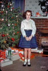"Janet, Christmas 1959." We return to the Baltimore home of Kermy and his sister, who has the look of a kid who just got ... clothes for Christmas. 35mm Kodachrome slide. View full size.