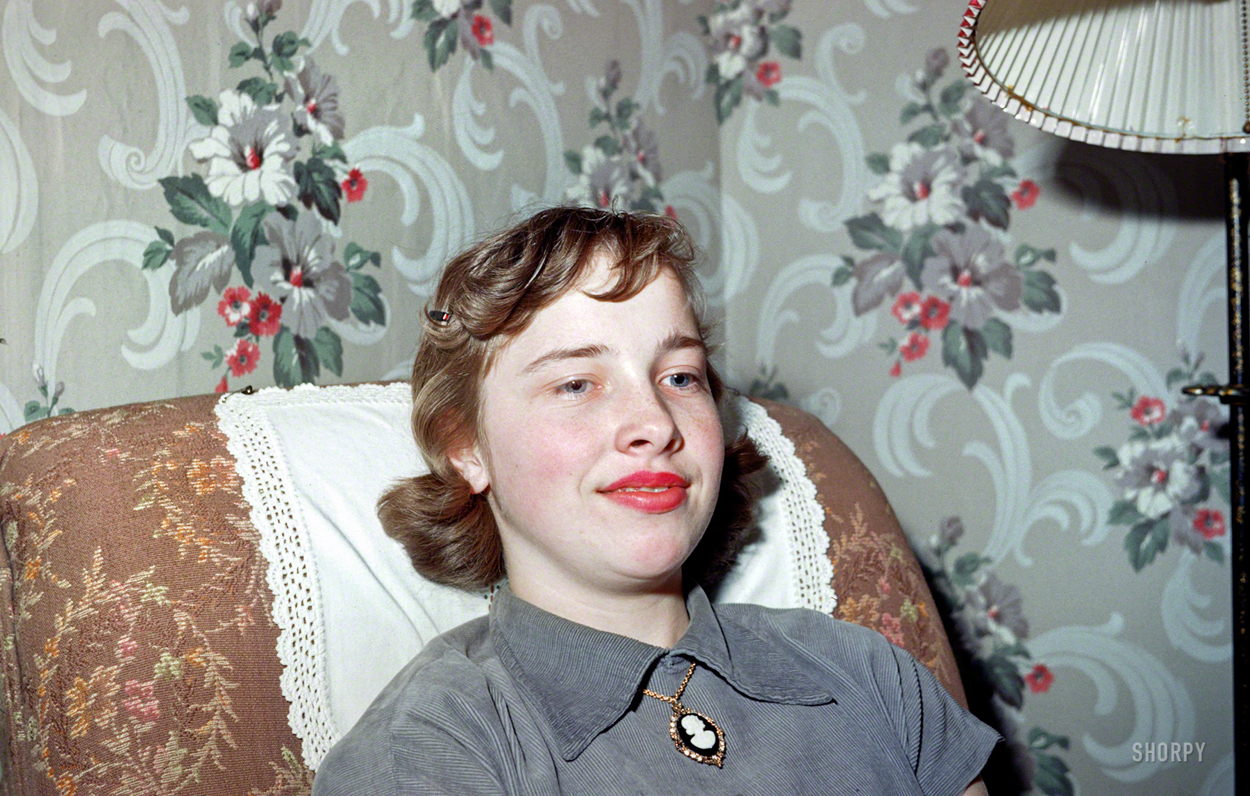 "Nadine -- April 1952." The newest cast member of Minnesota Kodachromes takes a break against the mandatory multifloral backdrop. View full size.