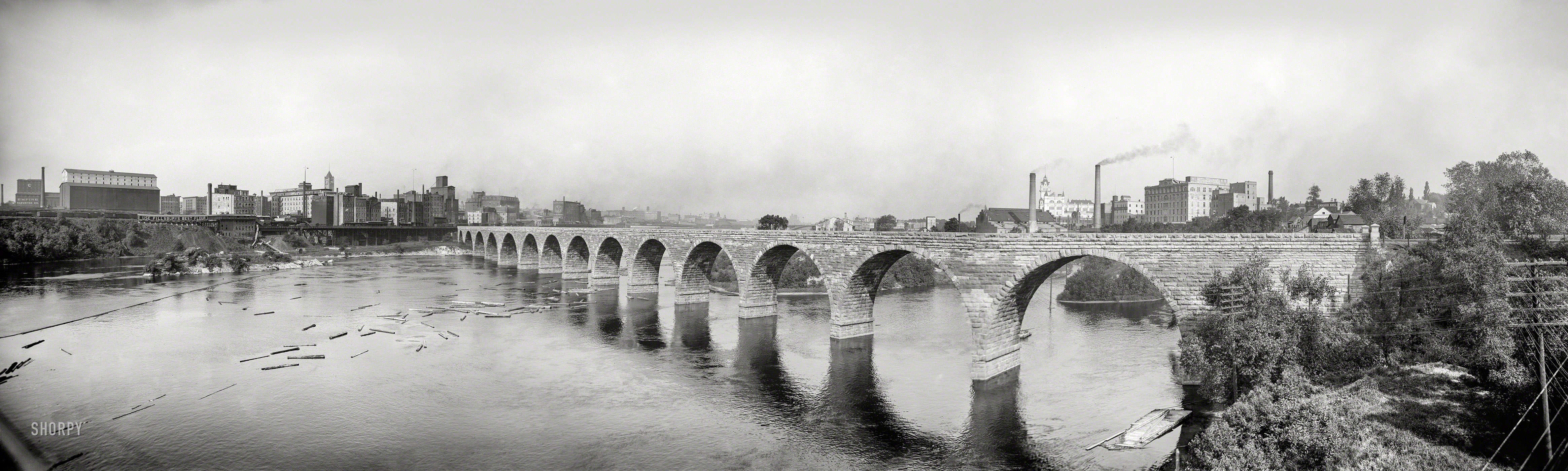 Minneapolis, 1905. "Stone Arch Bridge, which carries railroad traffic over the Mississippi River." Panorama from three 8x10 glass negatives. View full size.