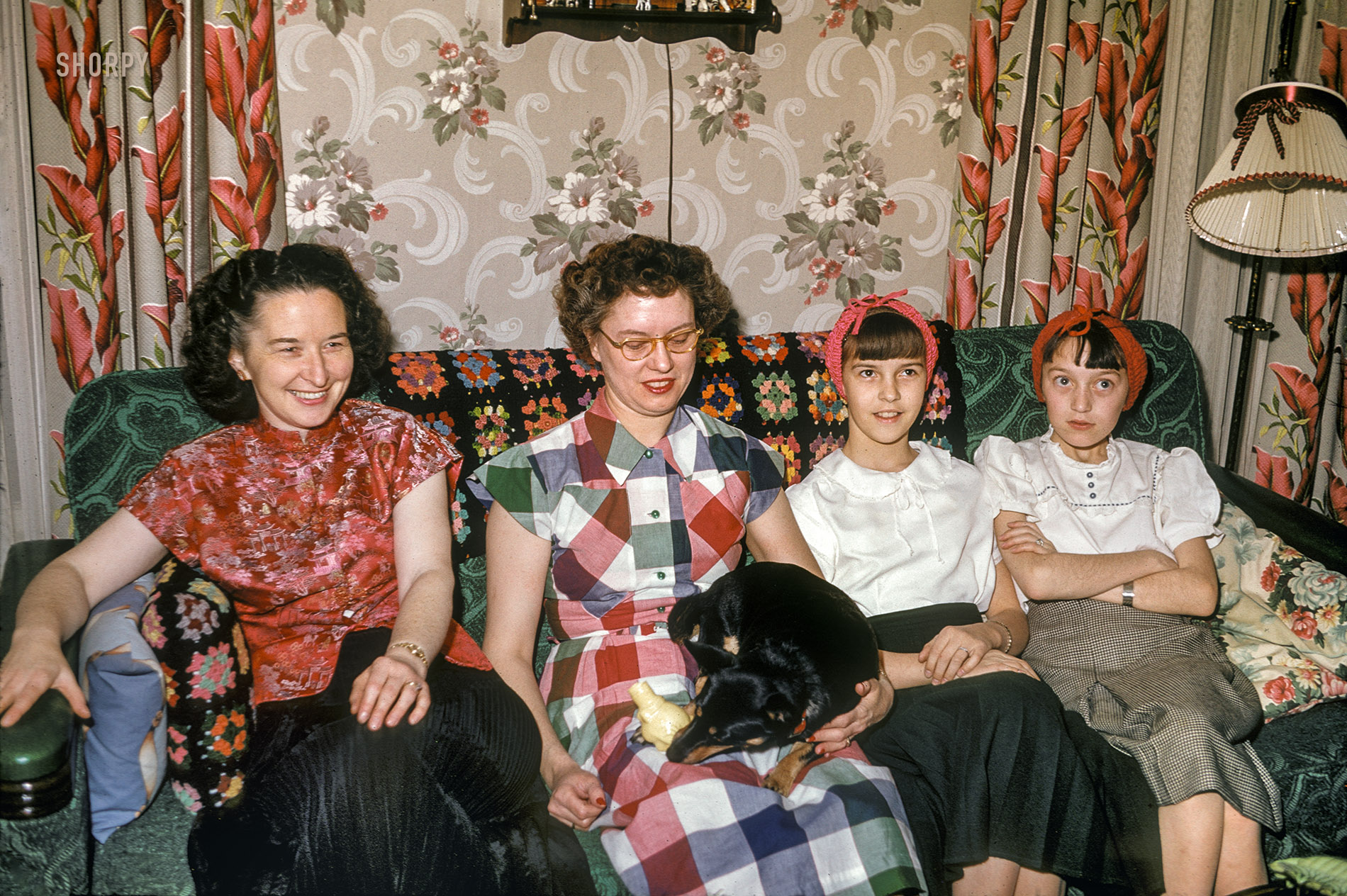 Feb. 9, 1952. "Grace, Dottie, Shirley, Koleen." With Boots the dog, ensconced on Grace and Hubert Tuttle's emerald sofa in Blue Earth, Minnesota. Kodachrome by Hubert. View full size.