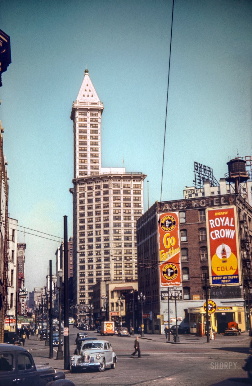 "Seattle 1942" is the notation on this latest Kodachrome from photographer-hotrodder Don Cox. At opposite ends of the architectural spectrum we have the Smith Tower, completed in 1914, and the Ace Hotel, one of which both of which still stand. View full size.

