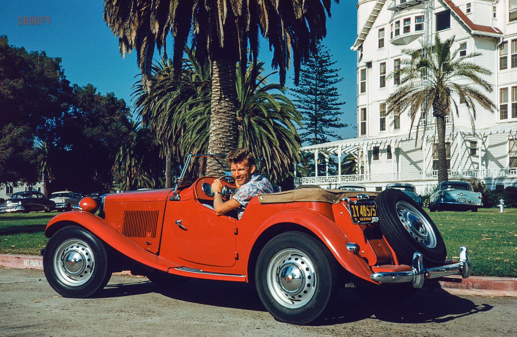 From 1953 comes this 35mm Kodachrome of hot-rodder and finer-things-appreciator Don Cox in a Tabasco-red MG at the Hotel Del Coronado in San Diego. Wanna race? View full size.