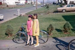 From around 1970, somewhere in Suburbia, comes this Kodachrome of two lovely lasses attired in Easter egg pastels, and a tricycle not long for this world. View full size.
