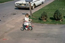 Here we are back on Schwinn Street, which turns out to be in ... New York. With a teensy tyke on yet another tiny trike. 35mm Kodachrome slide found on eBay. View full size.