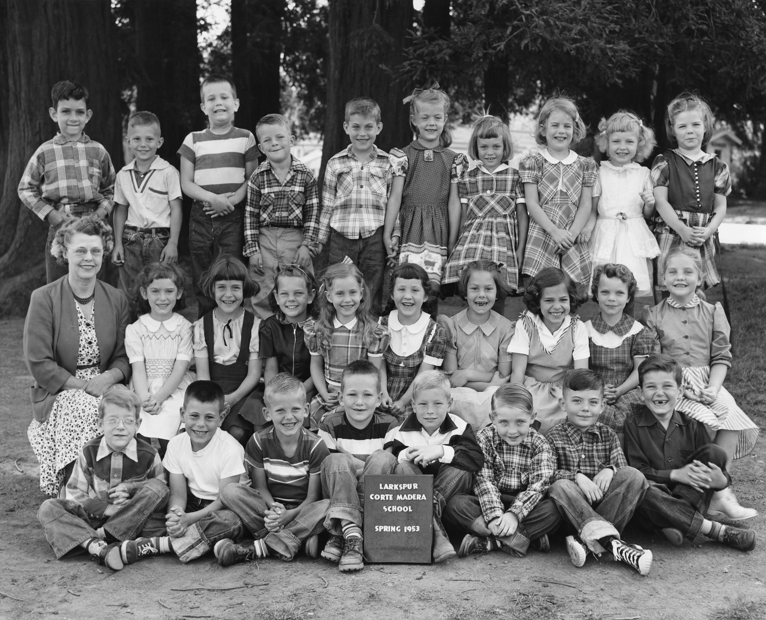 It's seventy years ago in Idyllic Larkspur™, where we find me (bottom left corner) with Bob, David, Bob, Jim, Jim, Margaret, Sandy, Donna, Rae Ann, Roberta, Virginia, Jerry, Buzzy, Fred, Gordy, Frances, Alice, Alice, Sheila, Mrs. Madeline Drew and others whose names I forget. This was taken within a month of losing nearly half our classmates, they having been siphoned off to the district's brand new school in neighboring "Twin City," almost-as-Idyllic Corte Madera. And that one was already overcrowded, for which first-wave baby boomers such as we must shoulder the blame. As for me, good old L-CM was just four blocks from our home at 9 Arch Street, and I continued to walk the round-trip every school day, rain or shine, until I graduated 8th grade. View full size.