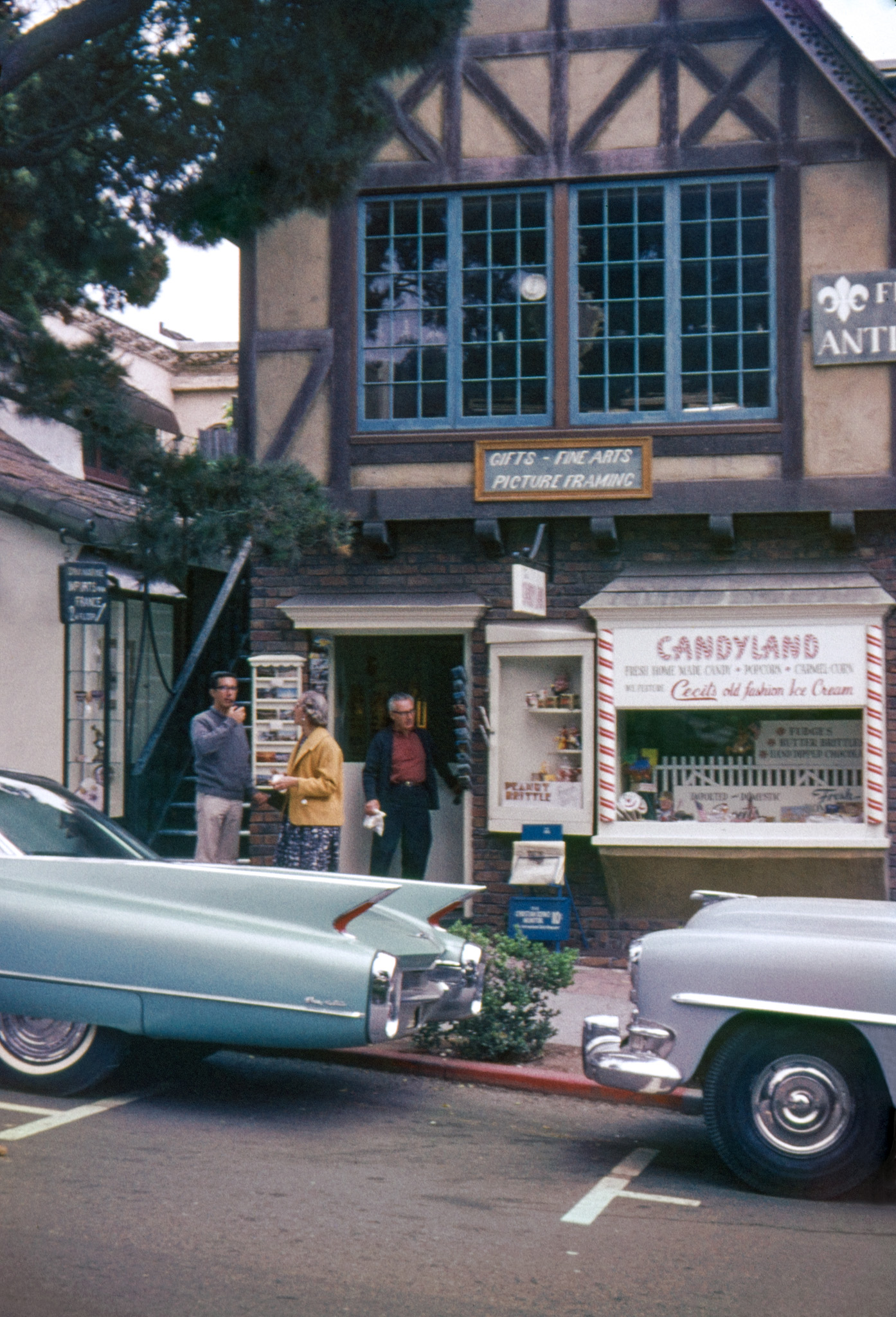 1962. It seems that parking places in Carmel, California were not designed with 1960 Cadillacs in mind. Lethal-looking enough to be giving my brother, mother and father second thoughts about jaywalking. 35mm Perutz slide. View full size.