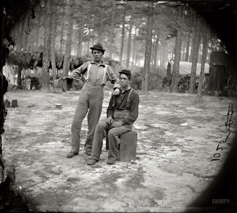 August 1864. "Petersburg, Virginia. Army of the Potomac. Two youthful military telegraph operators at headquarters." Habitues of the Victorian Internet. Wet plate negative, half of stereograph pair, by Timothy H. O'Sullivan. View full size.
