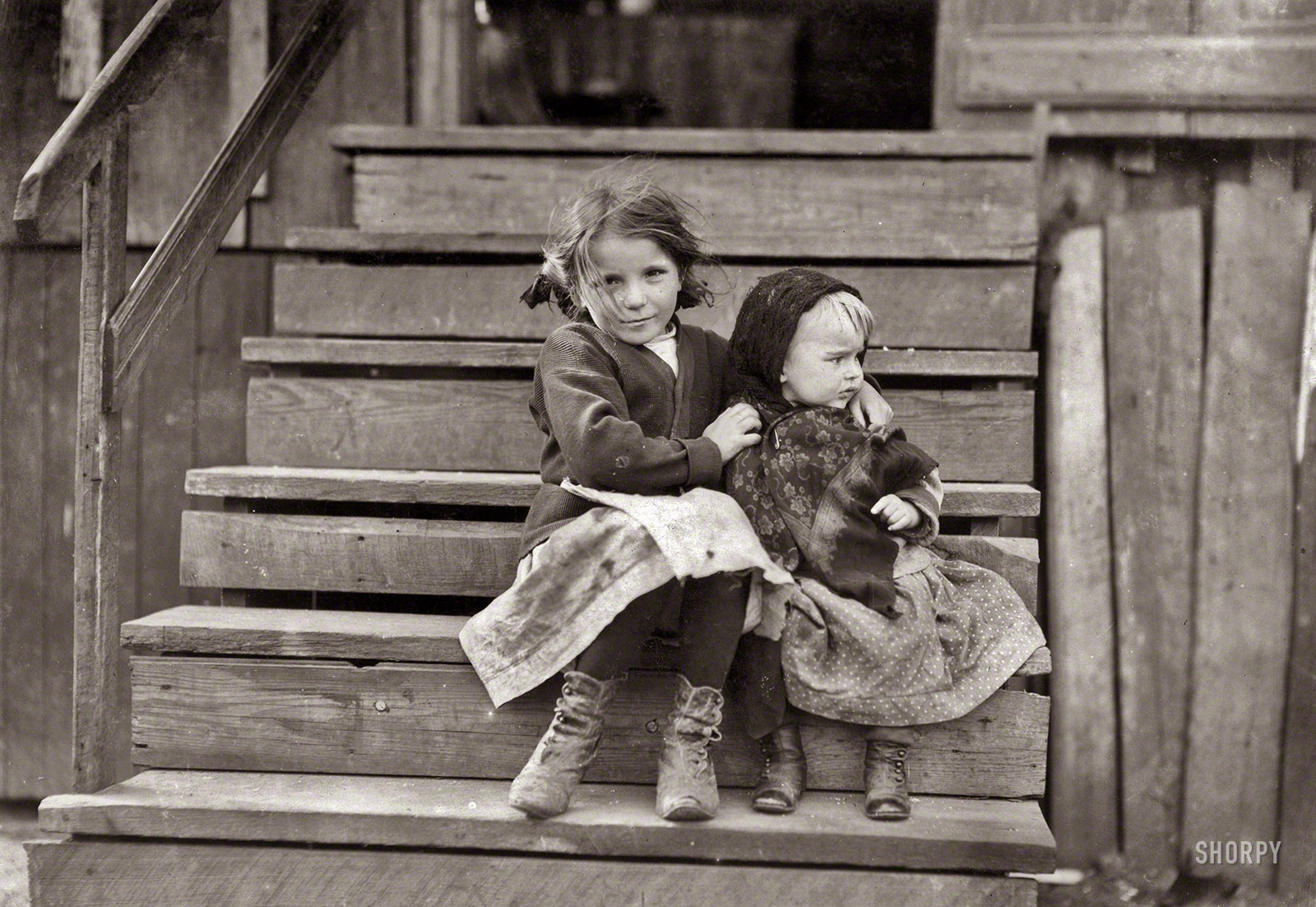 February 1911. Bayou La Batre, Alabama. "Little Julia tending the baby at home. All the older ones are at the factory. She shucks [oysters] also. Alabama Canning Co." Photograph by Lewis Wickes Hine. View full size.