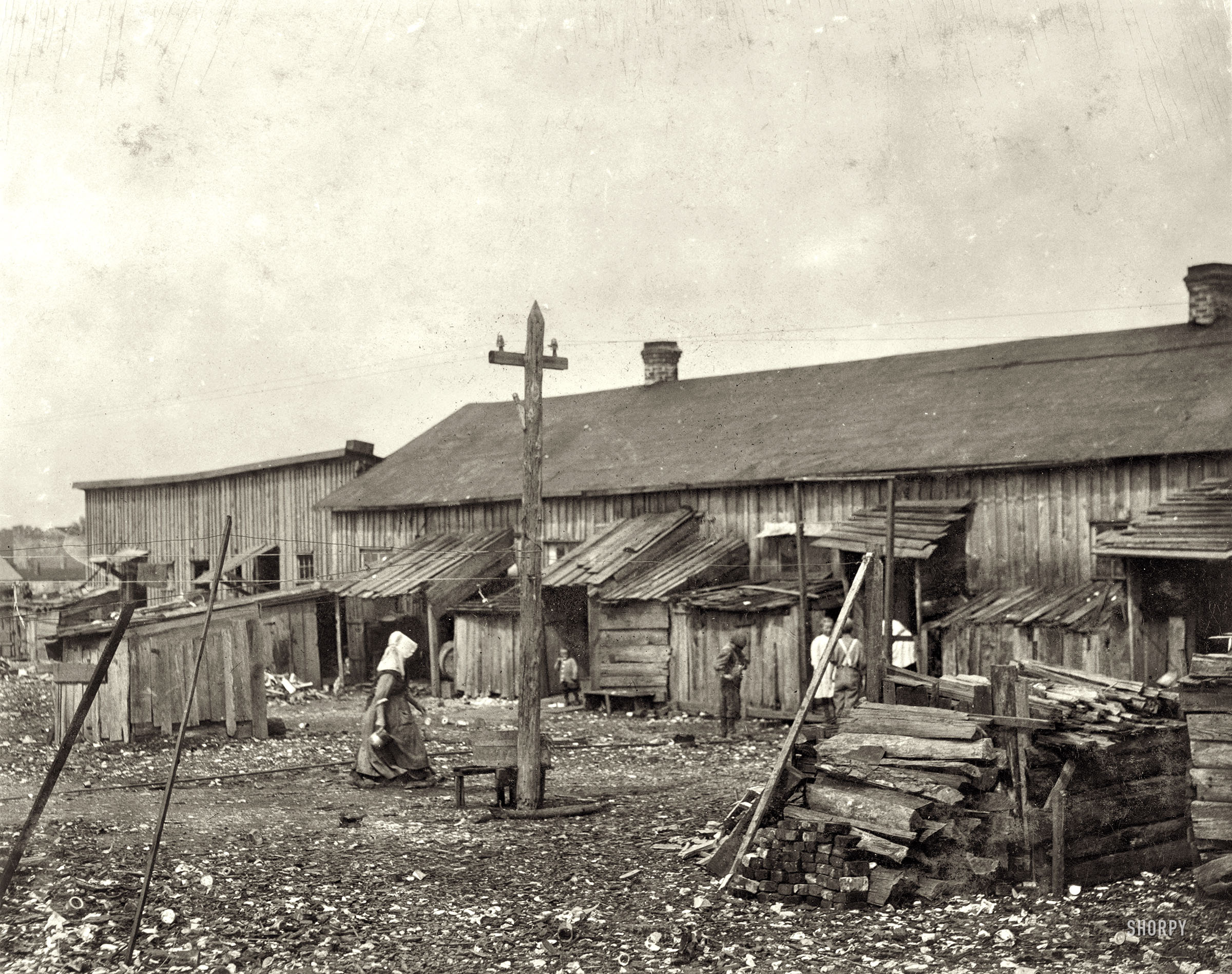 February 1912. Port Royal, South Carolina. "'We give them houses to live in.' About 50 persons housed in this miserable row of dilapidated shacks located on an old shell-pile and partly surrounded by a tidal marsh. Maggioni Canning Co." Photograph and caption by Lewis Wickes Hine. View full size.