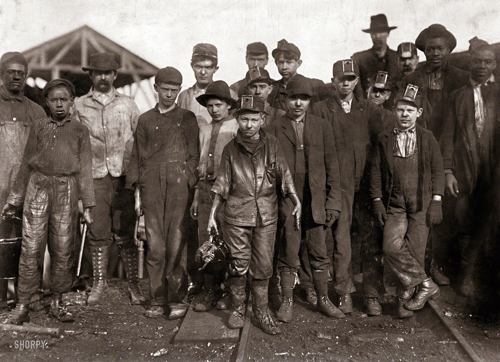 &nbsp; &nbsp; &nbsp; &nbsp; On Shorpy.com's seventh birthday, a look back at our namesake, the teenage mine greaser Shorpy Higginbotham, shown here in 1910 at age 14. His life was cut short by a mine accident in 1928, when he was crushed by a rock.
December 1910. Jefferson County, Alabama. "Shorpy Higginbotham, a 'greaser' on the tipple at Bessie Mine, of the Sloss-Sheffield Steel and Iron Co. Said he was 14 years old, but it is doubtful. Carries two heavy pails of grease, and is often in danger of being run over by the coal cars." Photograph by Lewis Wickes Hine for the National Child Labor Committee. View full size.