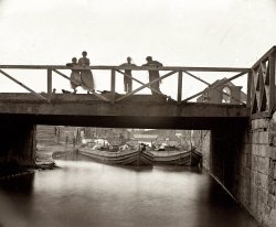 Spring 1865. Children on Canal Bridge at the foot of Seventh Street in Richmond after the fall of the city. Left half of a glass-plate stereograph. View full size.