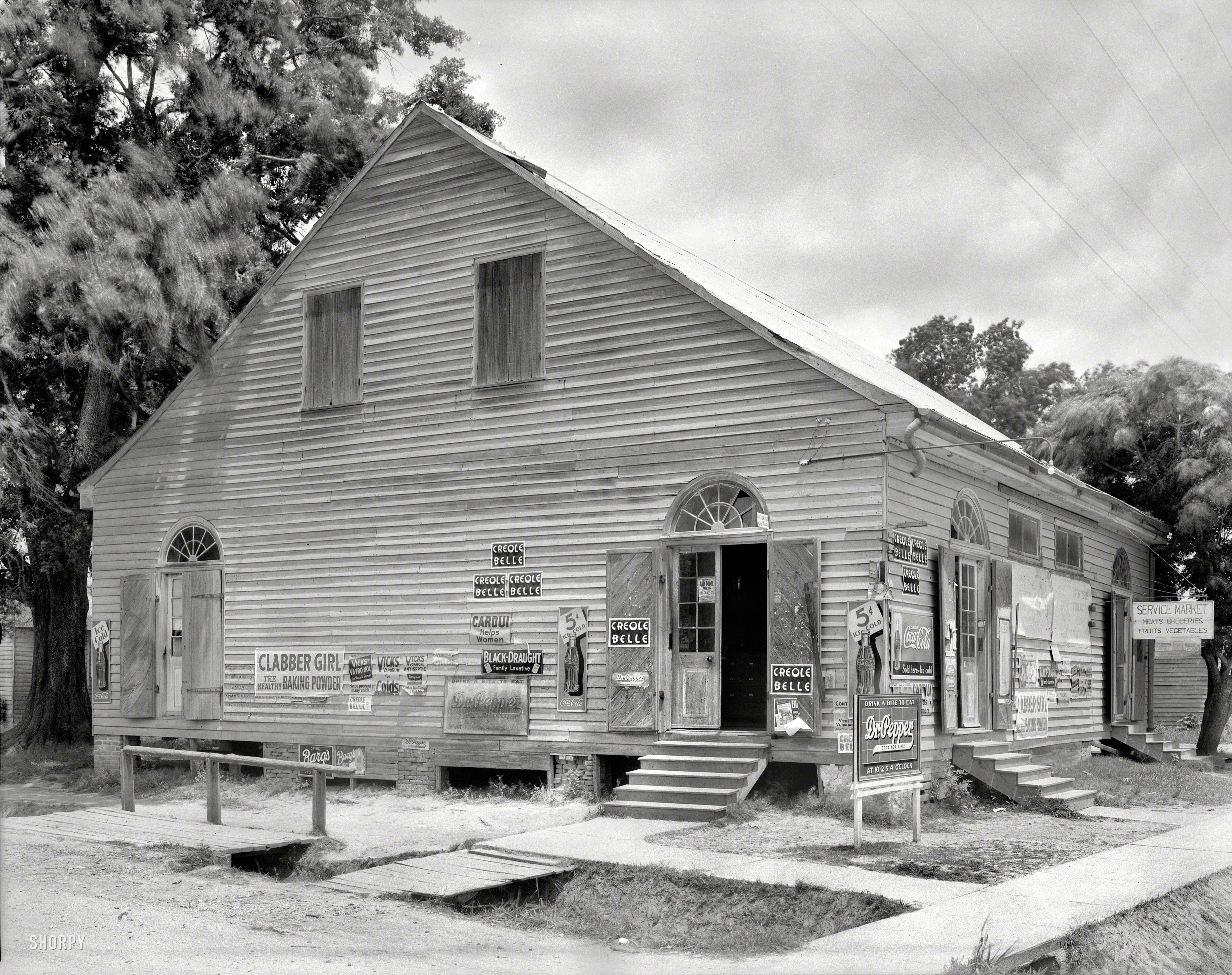 1938. "Petitin's Store, Grand Coteau, St. Landry Parish, Louisiana. Building dates to ca. 1834." While this ad-encrusted grocery might strike you as charmingly rustic, the Dr. Pepper sign seems to have so offended the photographer's sensibilities that for the other pictures she took, she draped it with a cloth. 8x10 acetate negative by Frances Benjamin Johnston. View full size.