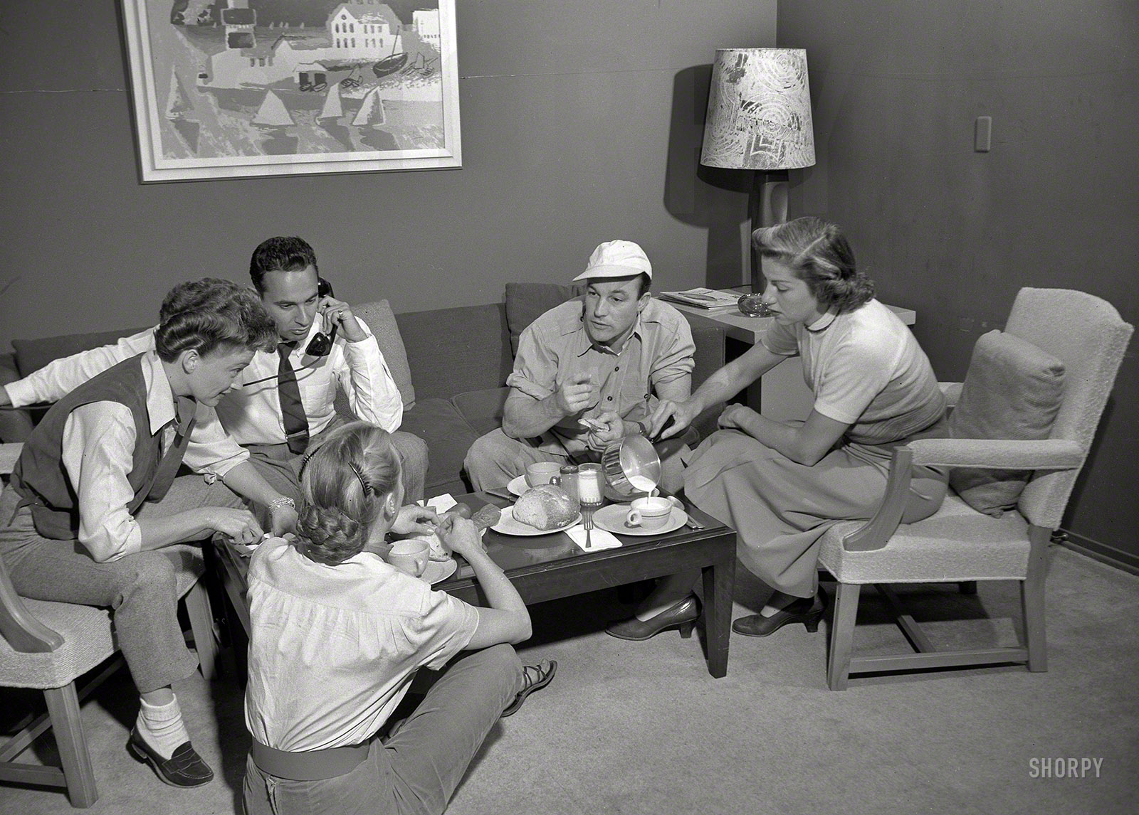 February 1952. "Entertainer Gene Kelly with others having coffee." The star and his satellites. From photos by Maurice Terrell for Look magazine. View full size.
