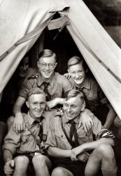 1938. Stuttgart, Germany. "Von der 6. Reichstagung der Auslandsdeutschen (Hitler Youth in tent during festivities for the 6th Annual National Days of Foreign Germans)." Photo by Heinrich Hoffmann, Kochstra&szlig;e 10, Berlin. View full size.
FooledI got this in the email version, and was scrolling down happily, thinking, "Aw, what cute Boy Scouts," when the swastika armband appeared, and "Gaaaah!" 
Meanwhile, the Fates ConspireI wonder how many of these poor deluded kids ended up on the Eastern Front, making the world safe for National Socialism?
Mandatory MembershipI concur with History Lover's assertion.  While stationed in Okinawa in 1970, I knew a USAF Chief Master Sergeant who had been in the Hitler Youth.  He came to the US in 1949 as a 19 year old and immediately joined the Air Force.  He also indicated membership was mandatory for all boys.  He did say that they occasionally had some para-military training and exposure to propoganda, but that for the most part, they built model airplanes, camped out and engaged in other typical scouting stuff.  You would not have likely found a more loyal American. 
Indian SummerYes, this is probably going to end badly for these young men.
Masonic LodgeYup, according to the sign with the skull and bones, these young Germans aspire to be Freemasons. But what's with the butter knife? 
More likeMaster Nerds.
Heinrich HoffmannHeinrich Hoffmann, who is credited with this photo, was Adolf Hitler's personal photographer. He owned a photography shop and originally employed Eva Braun, and introduced Hitler to her. His involvement with Hitler and Braun goes back to Munich in the early days of the Nazi Movement.
6th Annual National DaysMehr Information hier.
I don&#039;t likeSpeaking as a Pole, I want to state clearly that there is no positive associations and feelings, when I look at this photo. Sure, these guys were not guilty. Manipulated, fool, sorry, full of hope, the same as their younger Polish "friends" several years later: communists.
It is very sad, i met few people, so excited about Nazism, people from USA, young girls from good schools, reach families, for example. A little bit scary, isn't it?
MembershipThe two in front are members in the Hitlerjugend, the three in the back are members in the Deutschesjungvolk.
Too sadAs was stated, how many of those kids ended up in a Soviet Gulag paying for the sins of their leaders. The uniforms are those of the Hitler Youth, which replaced the Scouting movement in 1933.
A good friend of mine was taken to this fest by his mother (a naturalized German-American). When he started asking questions about the goings-on (he was 10 at the time), some of the older kids took him out and beat the crap out of him. When he went home to New York State, he never once looked back. I guess that they were well indoctrinated.
No ChoiceI had a boss back in the early 1970s who's wife was born and raised in Germany. He met her while stationed there after WW2, around 1945. She claimed that all boys and girls of a certain age were required to join a Hitler youth group (don't know the exact name), with the emphasis on required. Anyway, she certainly did not seem to have a problem with marrying a soldier from the U.S., leaving Germany, and raising two children here. So I always had a tendency to believe her story.
85% mortality rateMy 90-year-old father-in-law was born in Austria and spent the war years there before emigrating to Canada.  As with all other youth, he was in the “boy scouts,” then in the army.  Of the twenty boys in his high school class, only three survived the war.
(Camping, WW2)