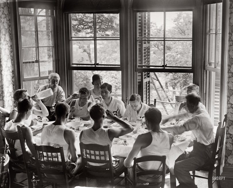 Syracuse freshmen on the rowing team sit around the dinner table on June 19, 1908. View full size. George Grantham Bain Collection.
