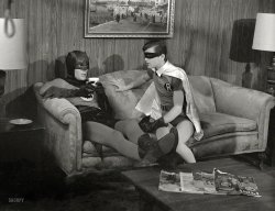 Gotham City in 1966. Batman and Robin (Adam West and Burt Ward) in an unguarded moment in the Bat-Cave (or perhaps on the Bat-Set) with the Bat-Mug. Photo by Richard Hewett for Look magazine. View full size.