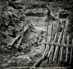April 3, 1865. Petersburg, Virginia. "Dead Confederate soldiers in trench beyond a section of chevaux-de-frise." Wet plate glass negative. View full size.