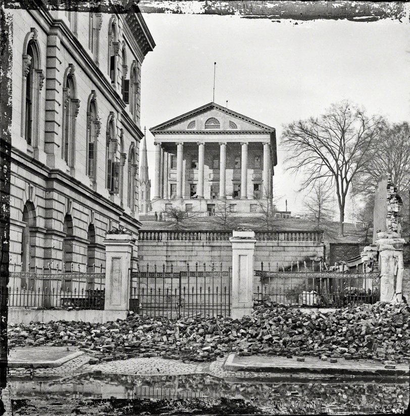 April 1865. "Fallen Richmond -- Custom House (left) and Virginia State Capitol; rubble in street." Wet plate glass negative. View full size.
