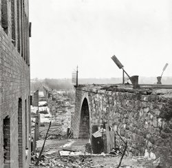 April 1865. "Richmond, Va. Ruins of Richmond & Petersburg Railroad bridge." Span over the James River, burned by Confederate troops before the advancing Federal Army. Wet plate negative by Alexander Gardner. View full size.