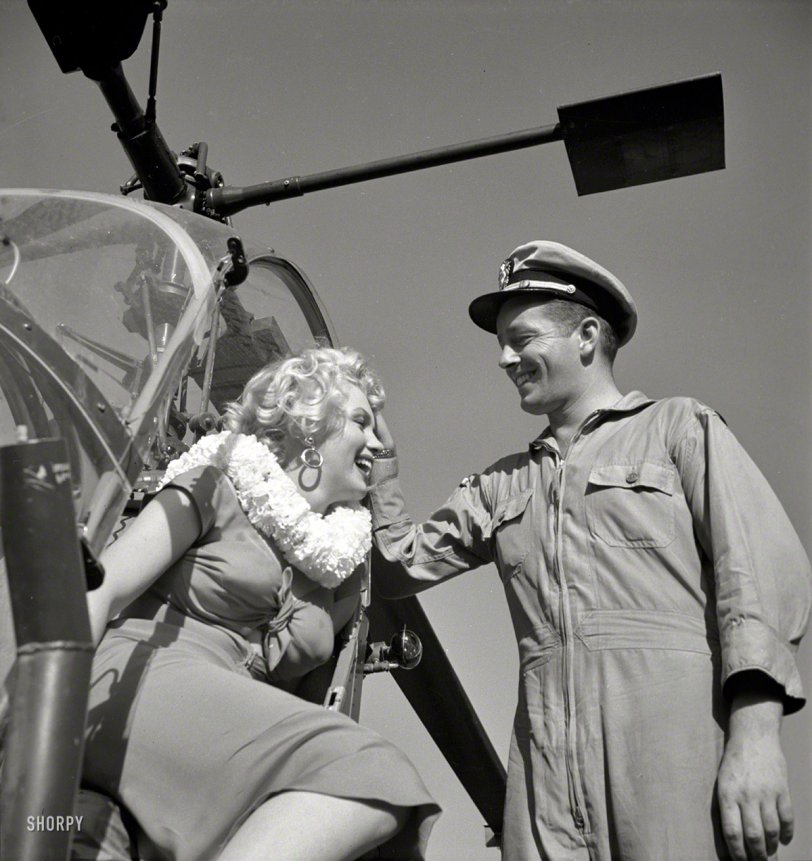 Marilyn Monroe and Navy pilot snapped by Charlotte Brooks in 1952 for the Look magazine assignment "Helicopter View of L.A." Also, a nice lei. View full size.
