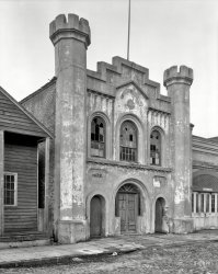 1937. Charleston, South Carolina. "Old Armory, 8 Chalmers Street. Original structure dates to 1851. Deutschen Feuer Kompagnie until merged with city fire department, then Engine House No. 1 by 1881; Carolina Light Infantry armory until 1907; then Good Samaritan Hall and Embry Mission. Abuts Old Slave Market." 8x10 acetate negative by Frances Benjamin Johnston. View full size.