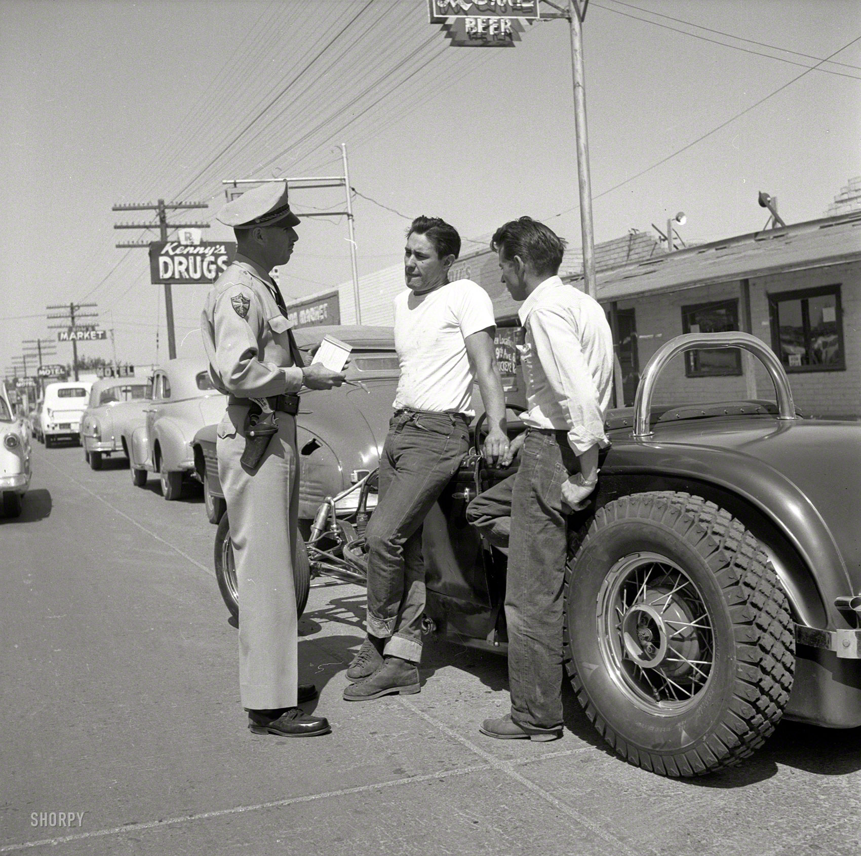 Phoenix in 1953. "Photographs show teenagers, mostly male, participating in the Maricopa County, Arizona, programs for teenage delinquent drivers. Includes boys working at Juvenile Farm; teens attending Attitude School; policeman with boys and their hot rods; teens driving on Phoenix streets." Photo by Earl Theisen for the Look magazine assignment "How to Tame Teenage Drivers." View full size.