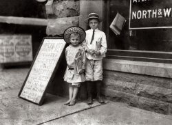June 1911. Norfolk, Va. "Teaching the Young How to Sell. Gus Hodges, age 11, instructing his brother Julius, age 5. I found Gus selling as late as 9 p.m., and he said that he had made over one dollar a day. Julius and another brother, 9 years old, had made 25 cents that day." Photo by Lewis Wickes Hine. View full size.